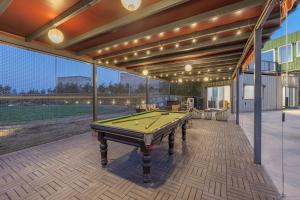 a pool table sitting inside of a house at ELIVAAS Hidden Oasis 4BHK with Pool, Mud House & Container House in Dhauj