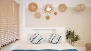 a bedroom with a bed with blue and white pillows at Yoghurt Home in Haad Rin