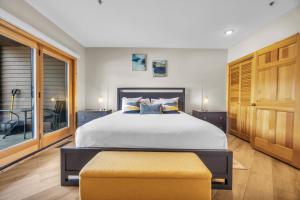 a bedroom with a large bed and a table at Steps From Ski Lift Garage Parking Included in Park City