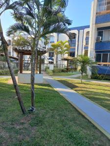 a palm tree next to a walkway in a park at Apartamento em Vilas do Atlântico in Lauro de Freitas +31 photos