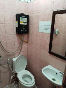 a bathroom with a toilet and a sink at Rumah Panjaitan in Yogyakarta +36 photos