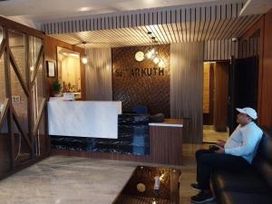 a man sitting on a couch in a lobby at Sagar Kuthi in Mandarmoni +99 photos