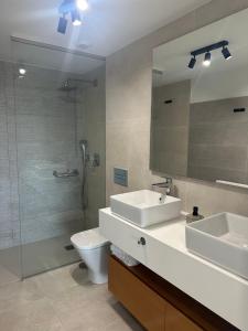 a bathroom with a sink and a toilet and a mirror at Beautiful Modern Town House - EDEN RESORT in Mijas Costa +18 photos