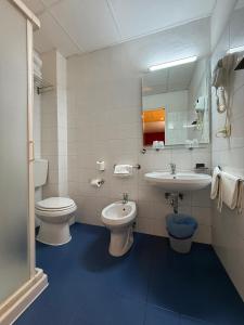 a bathroom with a toilet and a sink and a toilet istg at Hotel Meridiana in Florence +37 photos