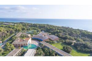 an aerial view of a house with the ocean in the background at Villetta Serra Alimini in Otranto