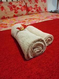 a towel with a watch on top of a bed at Le Bay Lodge in Gordonʼs Bay +45 photos