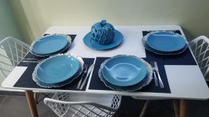 a table with blue plates and napkins on it at My Deligth in San Felipe de Puerto Plata