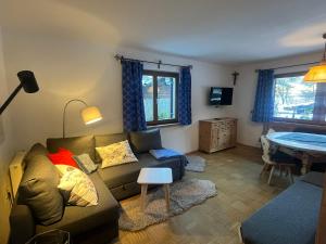 a living room with a couch and a table at Haus Fini - Ski In Ski Out in Kitzbühel