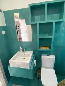 a bathroom with a white toilet and a sink at Beach Bungalows - Casal dos Patos - Villa Sul in Lourinhã +12 photos