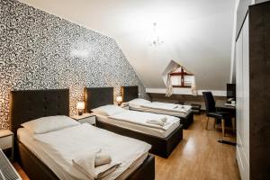 Postel nebo postele na pokoji v ubytování Hotel Panský dům