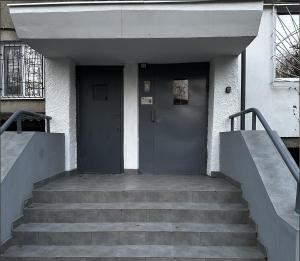 a building with a door and stairs in front at Best Location 2 Bedrooms in Chişinău +4 photos