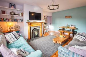 a living room with a couch and a fireplace at Host & Stay - Lilac Cottage in Morpeth