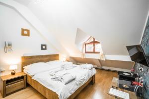 Postel nebo postele na pokoji v ubytování Hotel Panský dům