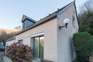 a house with a light on the side of it at Chalet 4 Personnes classé 3 étoiles in Esterre