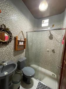 a bathroom with a shower and a toilet and a sink at Casa de Praia, em Belterra - PA in Belterra