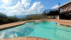 a swimming pool in a yard with a house at Tranquility Guest House in Sabie
