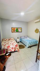 a bedroom with two beds in a room at Casa de Praia, em Belterra - PA in Belterra