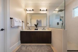 a bathroom with a sink and a mirror at Hihimanu House in Princeville +21 photos