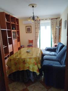 a living room with a table and a couch at Casamanuela in Aracena +16 photos