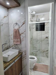 a bathroom with a sink and a toilet at B&B Conforto próximo ao Aeroporto in São José dos Pinhais