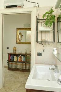 a bathroom with a sink and a mirror at B&B Il Riccio in Tirano