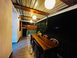a dining room with a long wooden table and chairs at Moonstone Holiday Cottages in Badulla