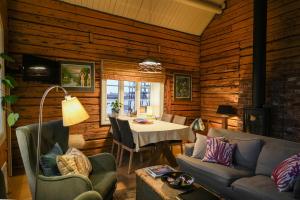 a living room with a table and a couch at The Famous Yellow House in Reine