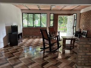 a living room with chairs and a table and a tv at Vacaciones Sol y Luna in La Tebaida