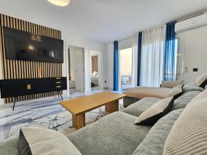 a living room with a couch and a tv at Mareverde Dream in Costa de Adeje