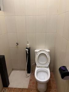 a small bathroom with a toilet and a shower at Jojo's Villa Batu in Batu +8 photos