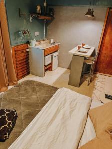 a small kitchen with a sink and a table at Apto Lince 2 Minutos do Parque Oktoberfest in Igrejinha +19 photos