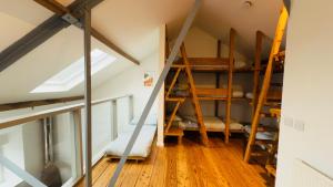 a room with bunk beds in the attic at Afan Forest Bunkhouse-Converted Chapel Sleeps 30 in Glyncorrwg +40 photos