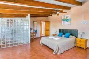 a bedroom with a large bed with blue pillows at Villa Verde Ciutadella by Villa Plus in Tres Alquerías