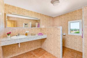 a bathroom with a sink and a mirror at Villa Verde Ciutadella by Villa Plus in Tres Alquerías +27 photos