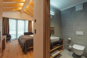 塔什Hotel Porta Cervino的一间带床、水槽和厕所的卧室