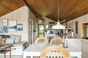 a kitchen and living room with a table and chairs at House By Forest And Roskilde Fjord's Waves in Jægerspris +27 photos