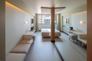 a hotel room with a bed and a couch at Hotel Arconte, Adults Only in Barcelona