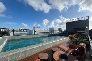 a swimming pool on the roof of a building at Get By Side na Beira mar do Caribessa Jardim Oceania in João Pessoa