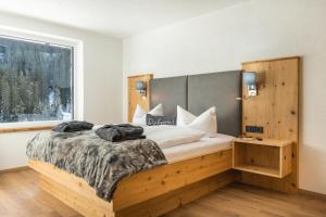 Posteľ alebo postele v izbe v ubytovaní sDahoam Luxury Chalet