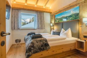 Posteľ alebo postele v izbe v ubytovaní sDahoam Luxury Chalet