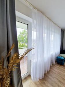 a room with white curtains and a large window at ARGENTA Living 129 in Künzell +33 photos