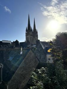 a view of a cathedral from the roofs of buildings at Côté Cathédrale - Grand studio Rue du Salé - Centre Historique in Quimper