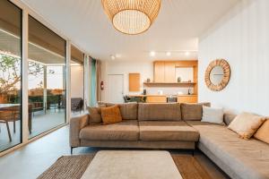 a living room with a couch and a kitchen at Villa Jerina Green Coast in Himare