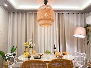 a dining room with a table with chairs and a light fixture at Gangseo House in Seoul
