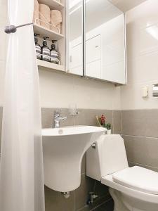 a bathroom with a sink and a toilet at Gangseo House in Seoul +52 photos