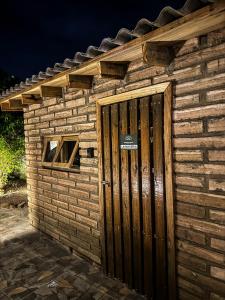 a small brick building with a wooden door at Espaços Cardoso, GRÊS - refúgio sólido e silencioso in Igrejinha +23 photos