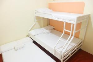 a small room with two bunk beds in it at Iloilo Transient Rooms Good for 15-20 pax in Iloilo City