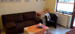 a living room with a couch and a table with candles at Zum Sauerländer Orketal in Medebach