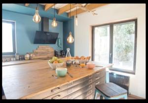 a kitchen with a wooden counter with fruit on it at Love room proche Rennes Le Cocon Enchanteur in Plélan-le-Grand