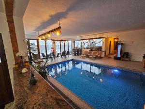 a large swimming pool in a living room with at Villa Adanis in Bihać
